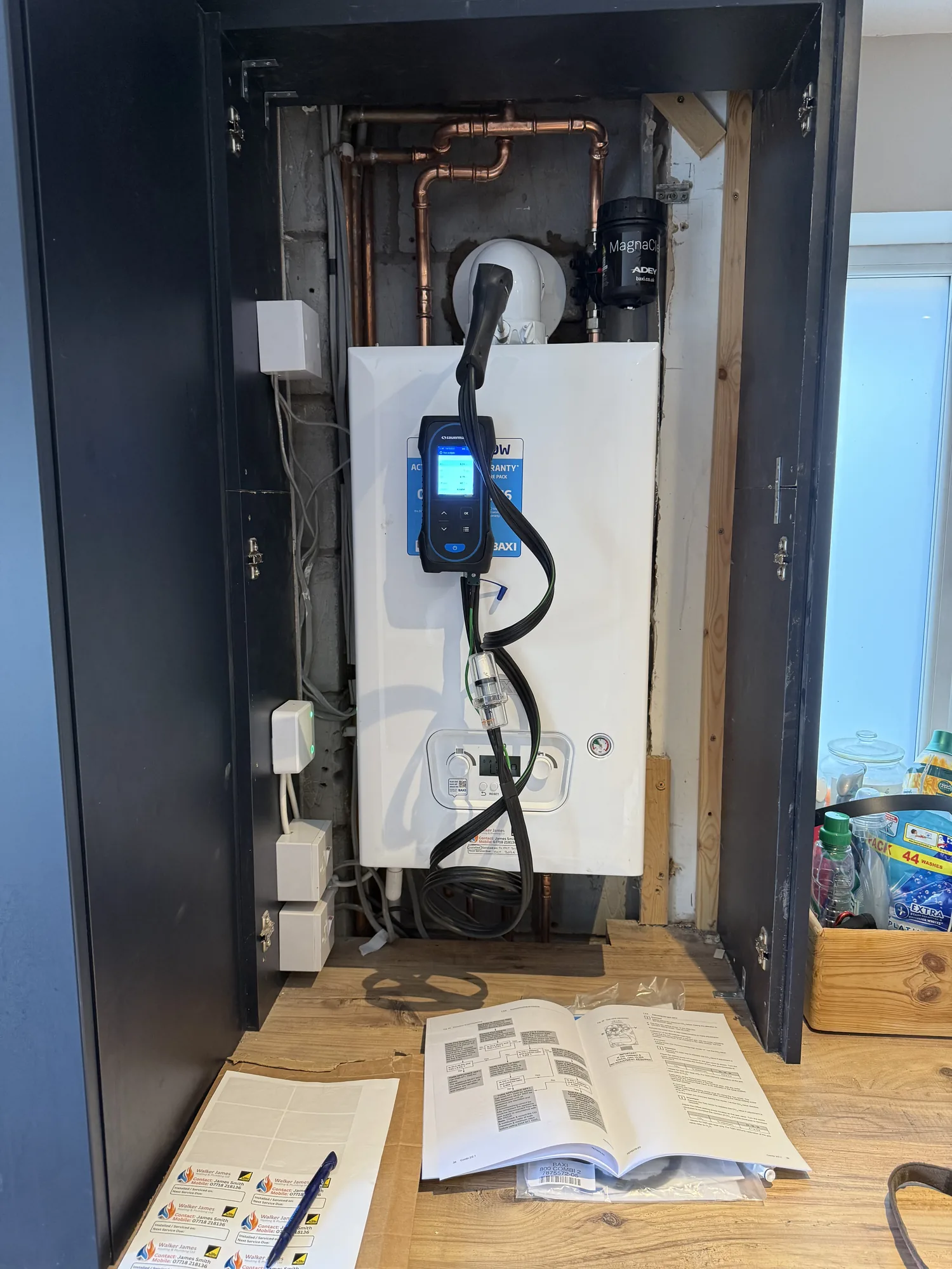 New boiler fitted inside a cupboard during commissioning