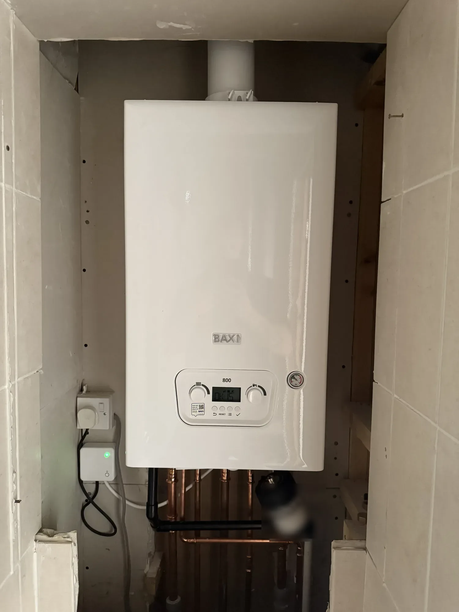 New Baxi combi boiler installed in a tiled cupboard by Walker James