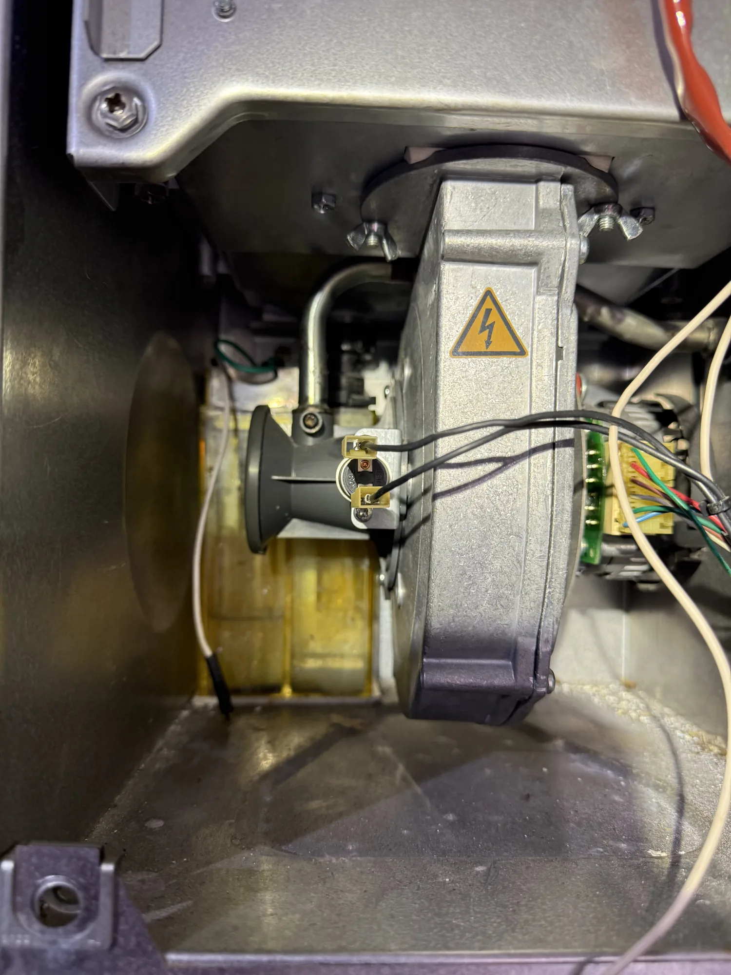 Inside a boiler during a service, showing the fan and air inlet